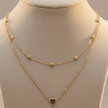 Gold necklace with a heart pendant on a mannequin neck.