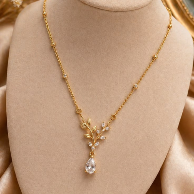 Gold necklace with a pendant on a beige mannequin bust