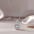 Silver necklace with a round diamond pendant on a soft beige background